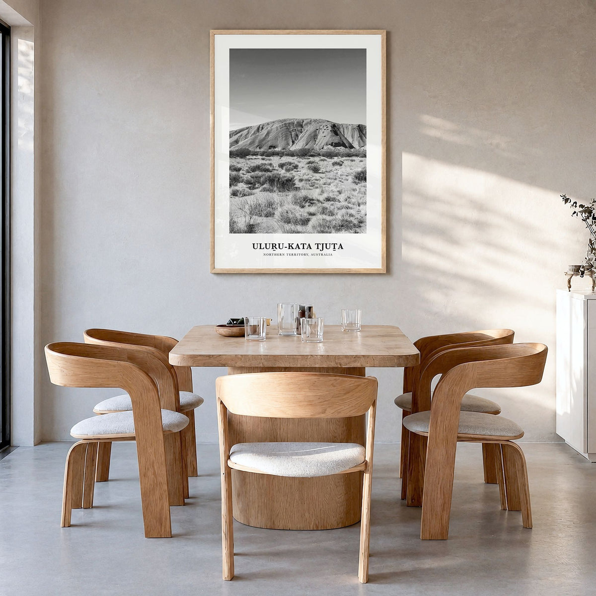 Uluru-Kata Tjuta Classic Poster in a natural wood frame, hanging in a dining room