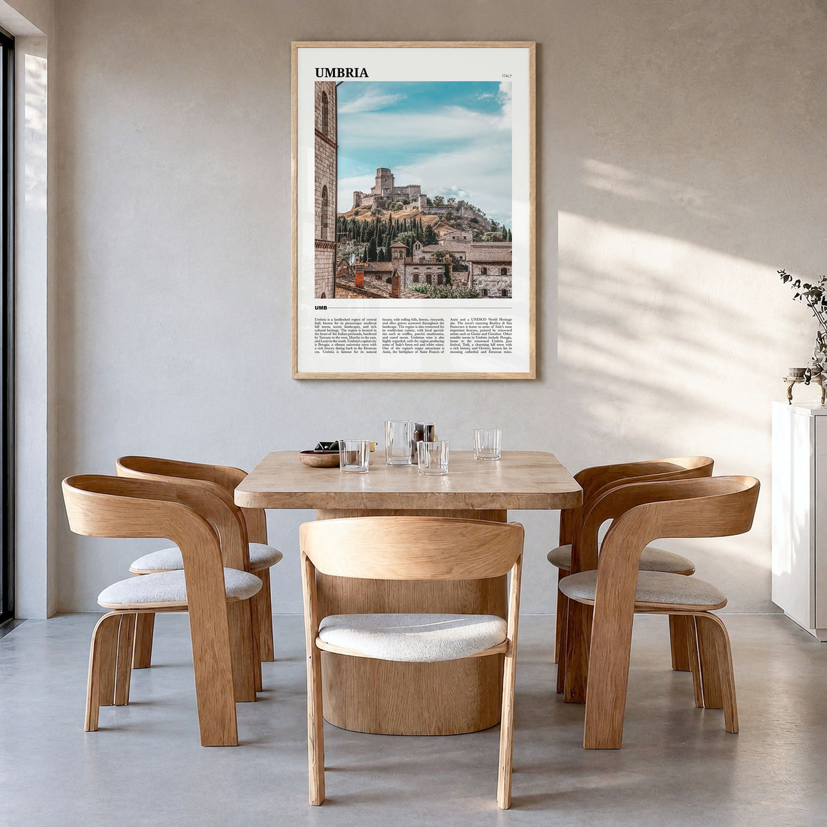 Umbria Travel Poster in a natural wood frame, hanging in a dining room