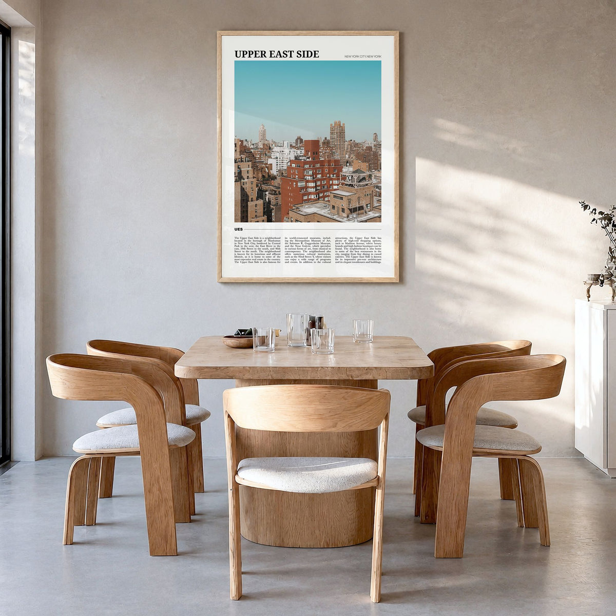 Upper East Side Travel Poster in a natural wood frame, hanging in a dining room