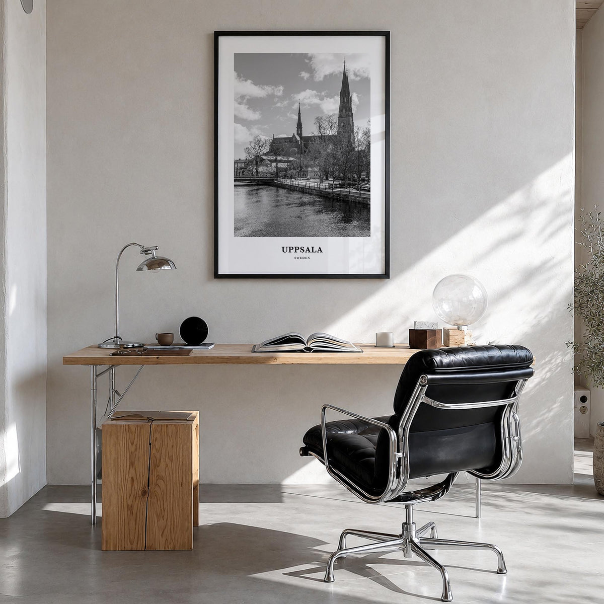 Uppsala black & white classic poster of Sweden – vertical wall art in black wood frame, hanging on wall