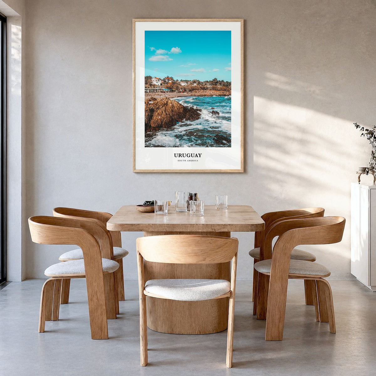 Uruguay Classic Poster in a natural wood frame, hanging in a dining room