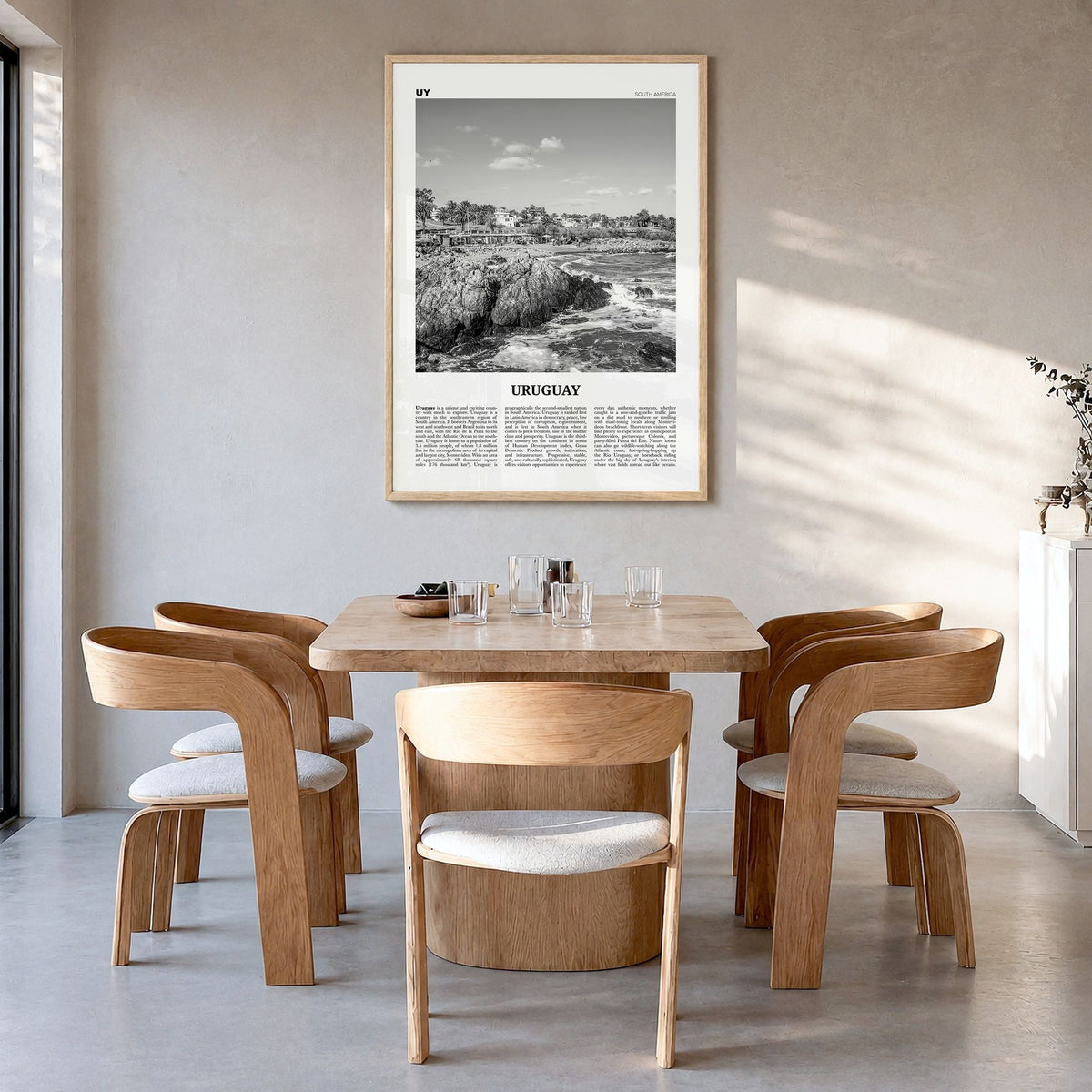 Uruguay Newspaper Poster in a natural wood frame, hanging in a dining room