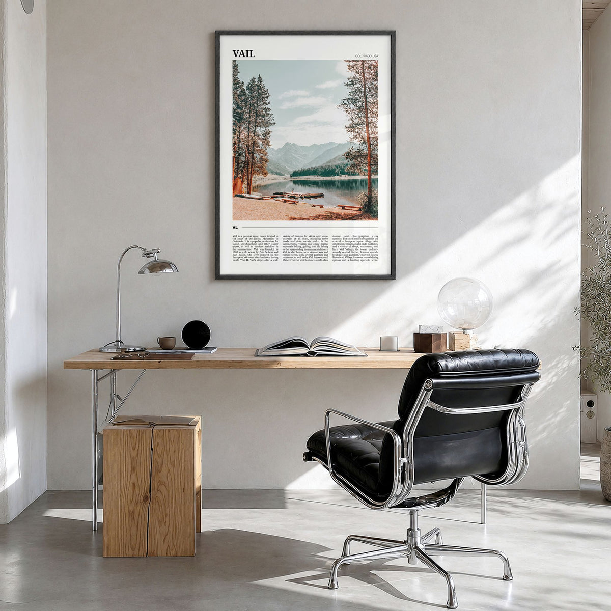Vail Travel Poster in a black wood frame, hanging in a bright home office