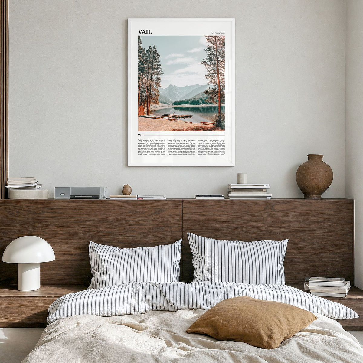 Vail Travel Poster in a white wood frame, hanging in a bedroom