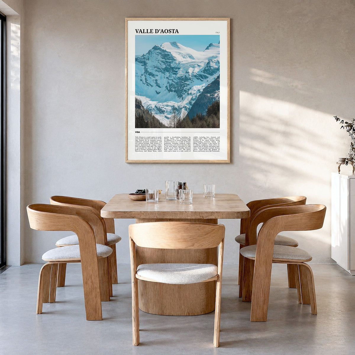 Valle d'Aosta Travel Poster in a natural wood frame, hanging in a dining room