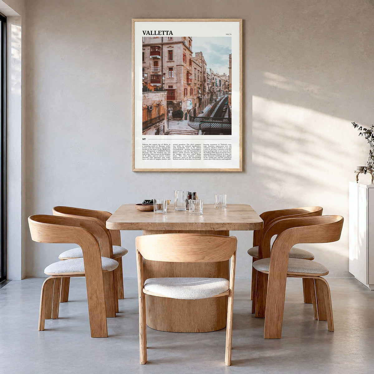 Valletta Travel Poster in a natural wood frame, hanging in a dining room