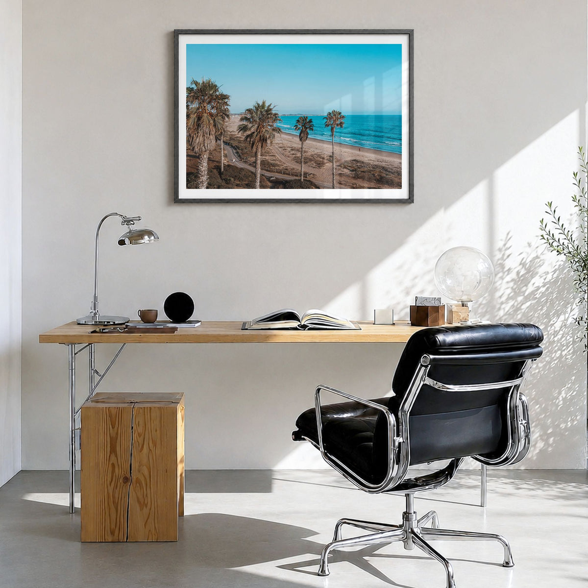 Ventura County Photo Poster in a black wood frame, hanging in a bright home office, white border