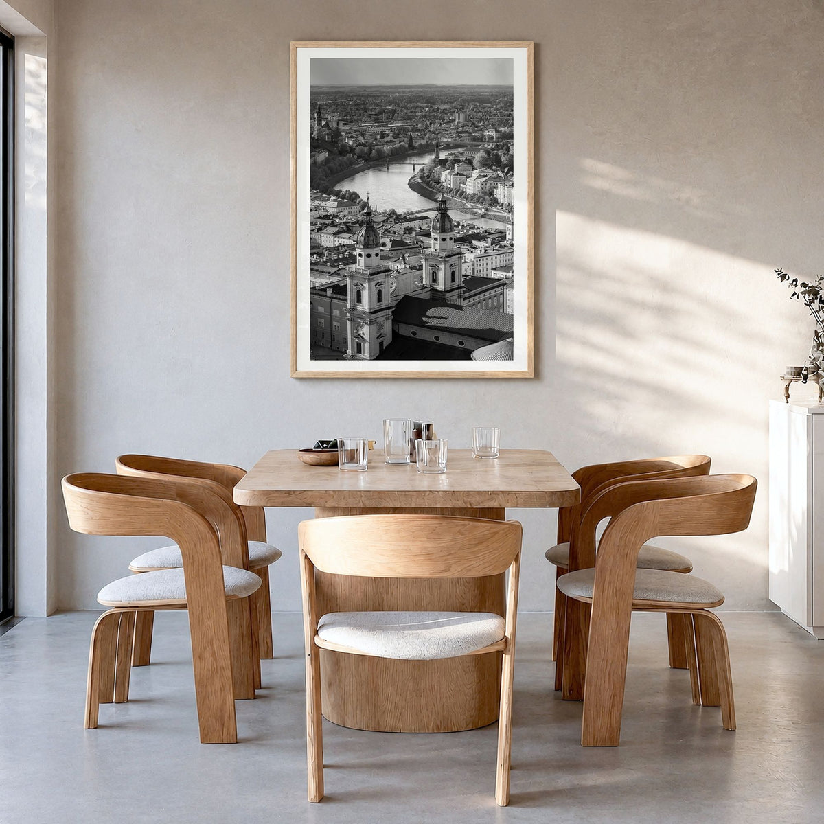 Vienna Photo Poster in a natural wood frame, hanging in a dining room, white border