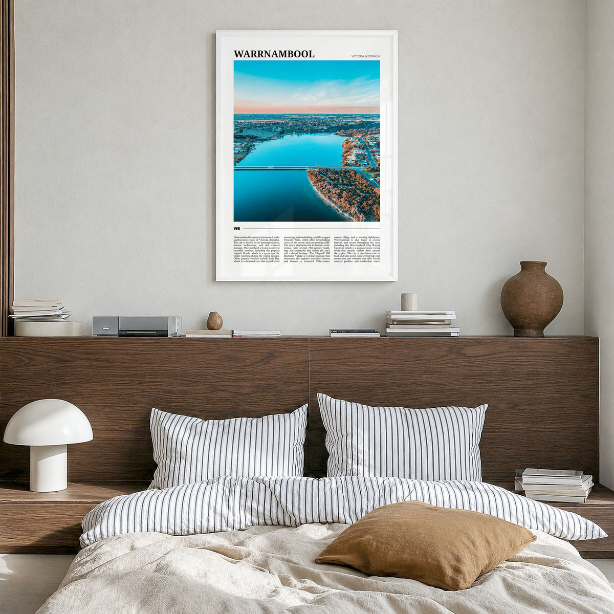 Warrnambool Travel Poster in a white wood frame, hanging in a bedroom