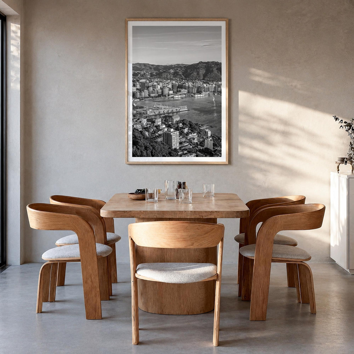 Wellington black & white photo poster of New Zealand – vertical wall art in natural wood frame with white border, hanging on