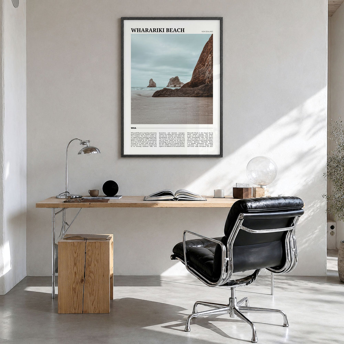 Wharariki Beach Travel Poster in a black wood frame, hanging in a bright home office