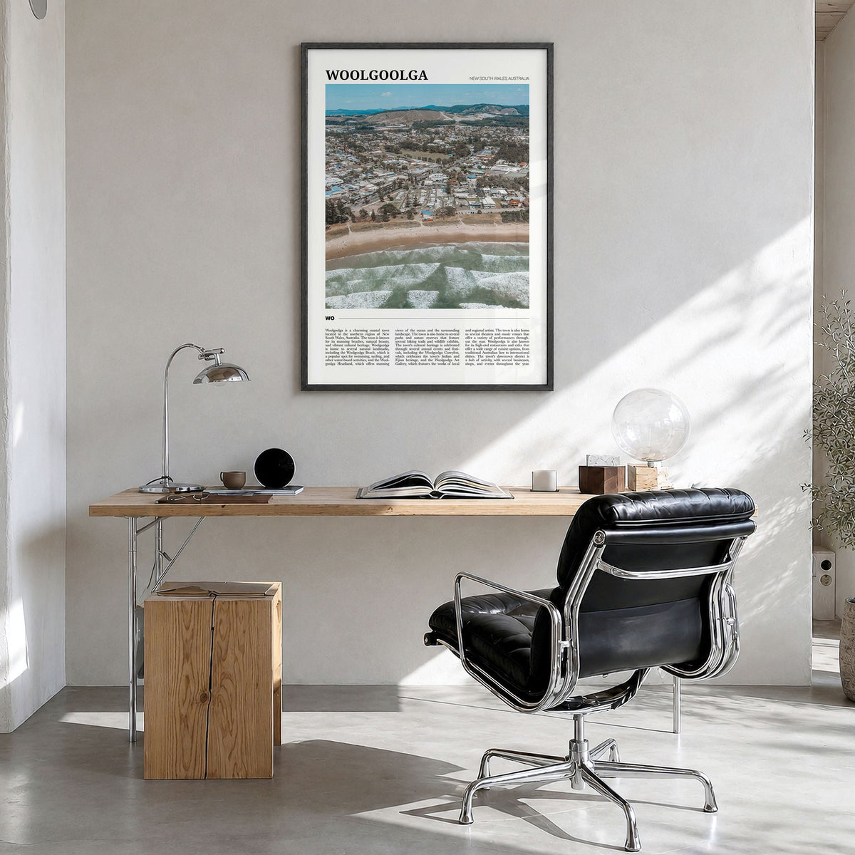 Woolgoolga Travel Poster in a black wood frame, hanging in a bright home office