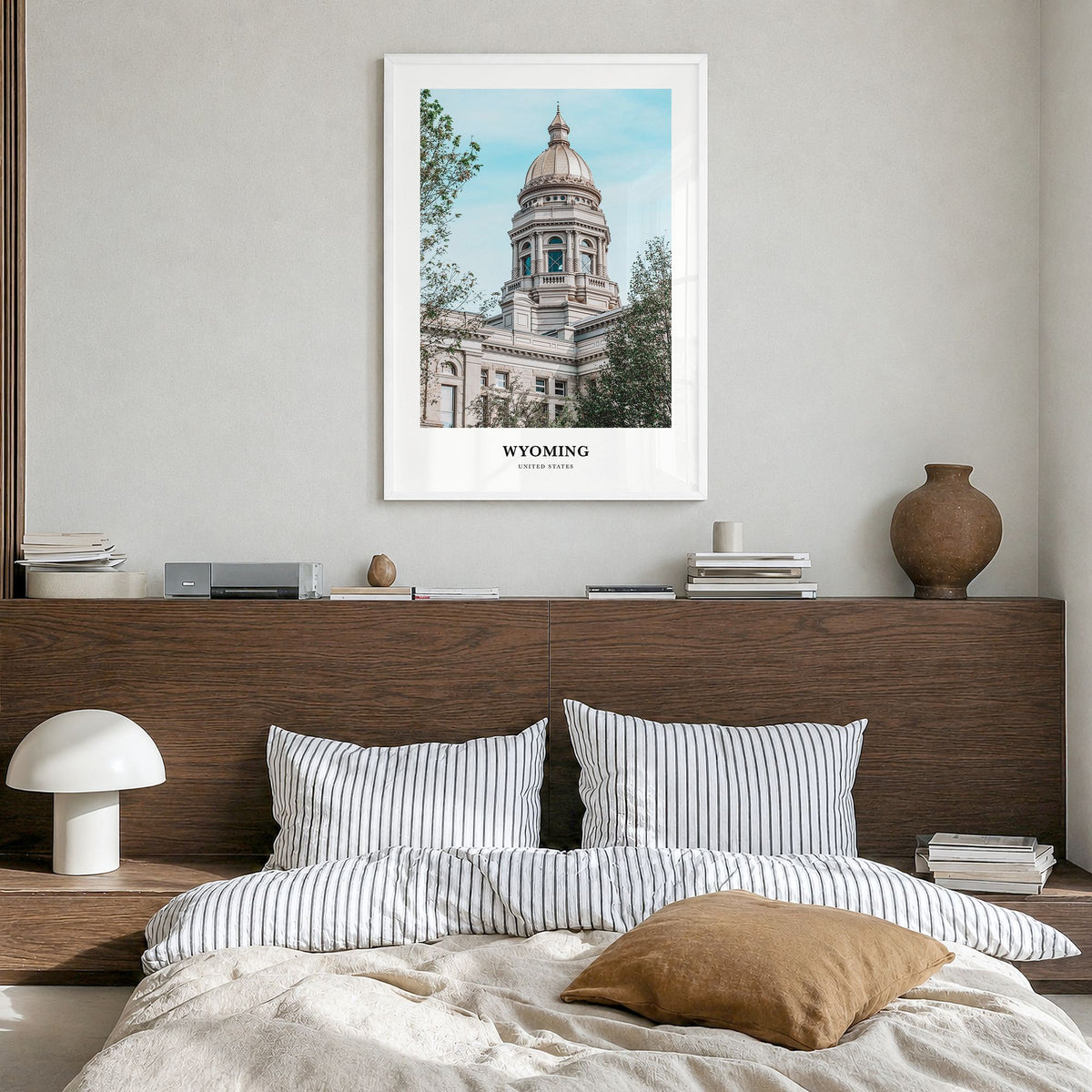 Wyoming Classic Poster in a white wood frame, hanging in a bedroom