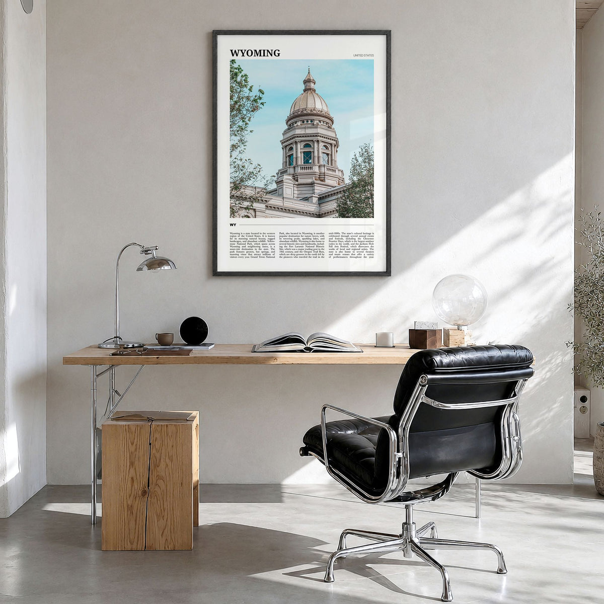 Wyoming Travel Poster in a black wood frame, hanging in a bright home office