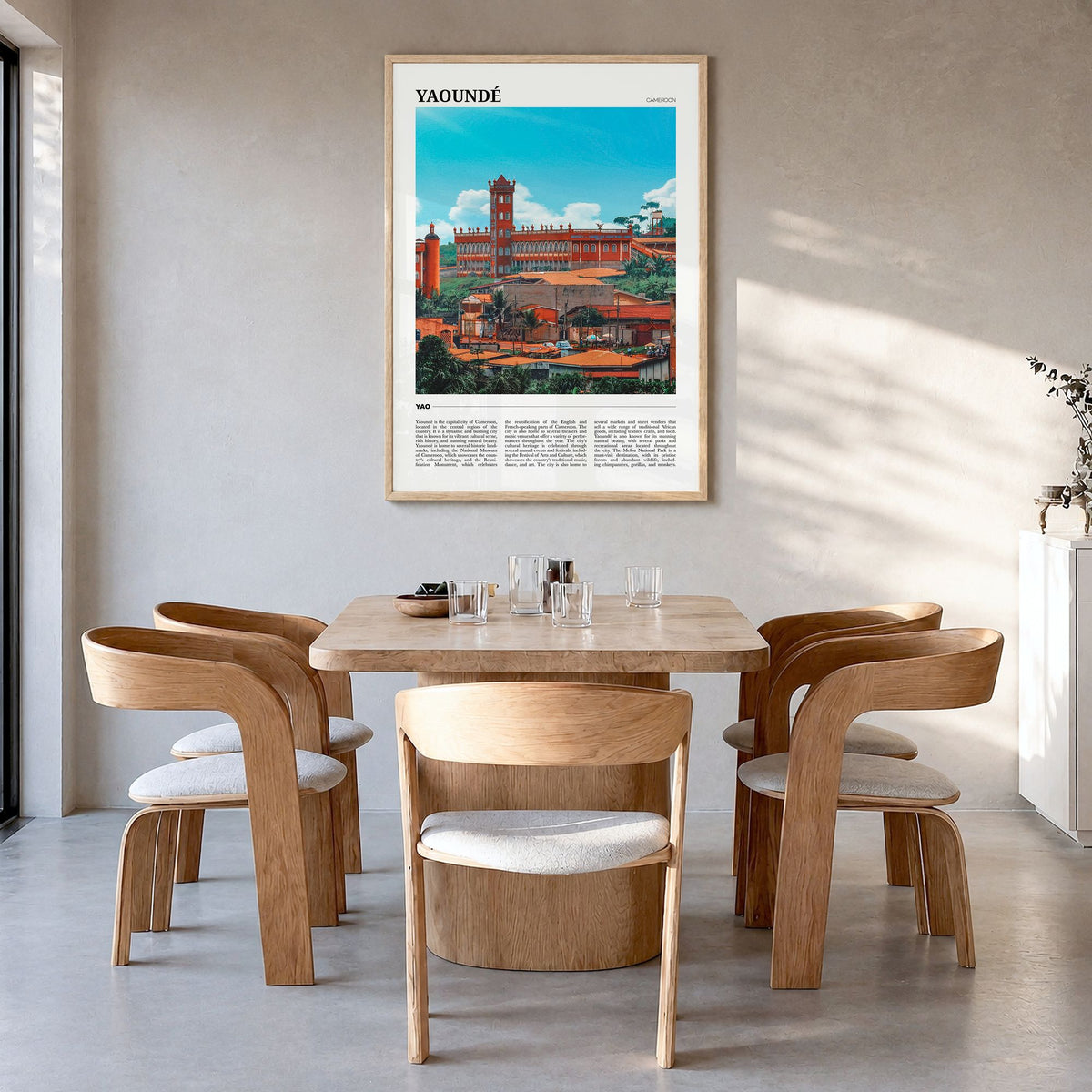 Yaoundé Travel Poster in a natural wood frame, hanging in a dining room