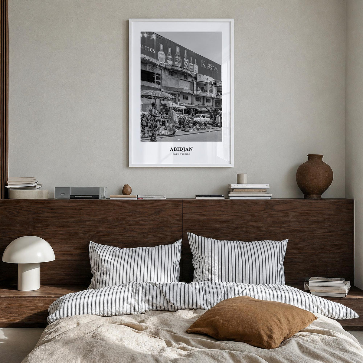 Abidjan black & white classic poster of Côte d'Ivoire – vertical wall art in white wood frame, hanging on wall