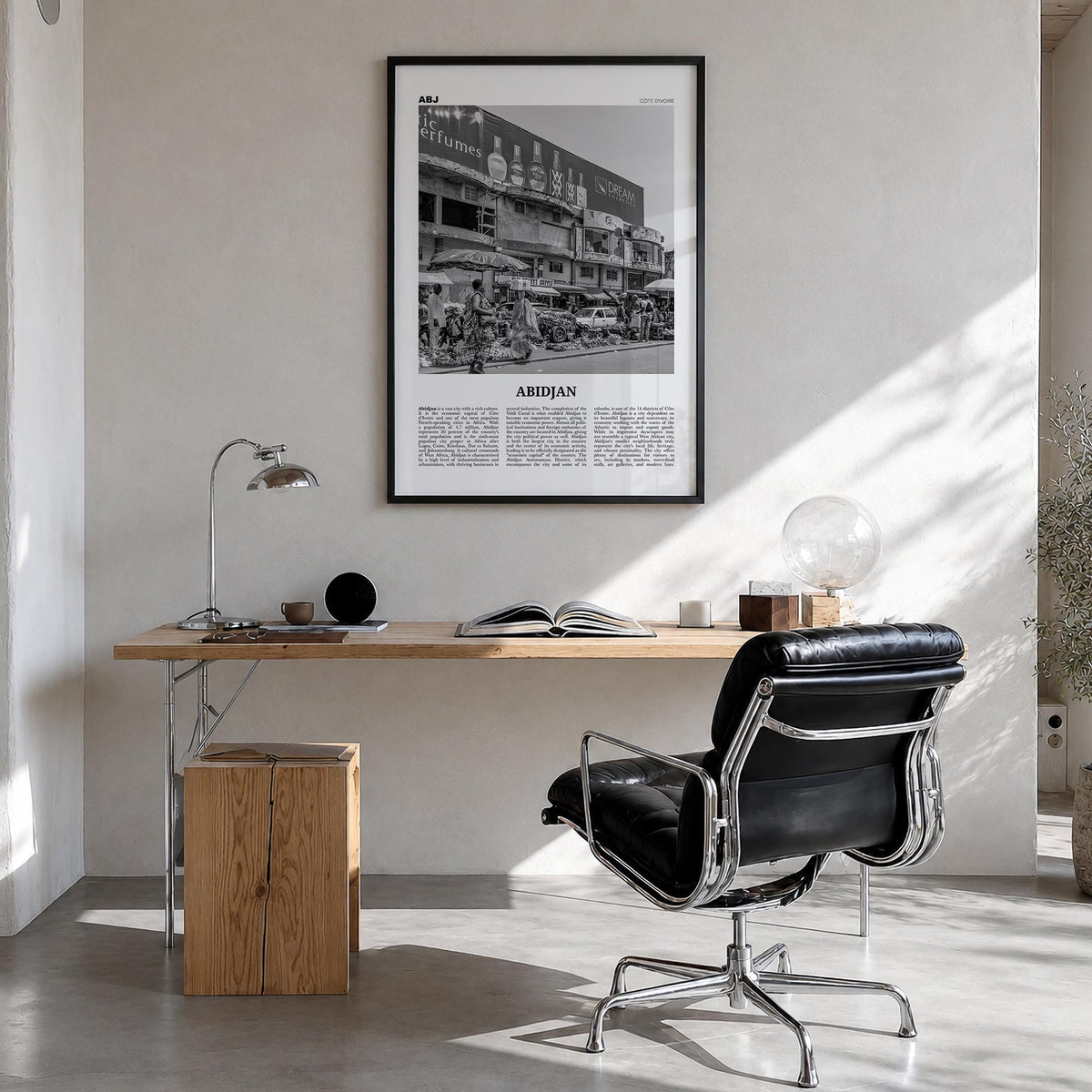 Abidjan black & white newspaper poster of Côte d'Ivoire – vertical wall art in black wood frame, hanging on wall