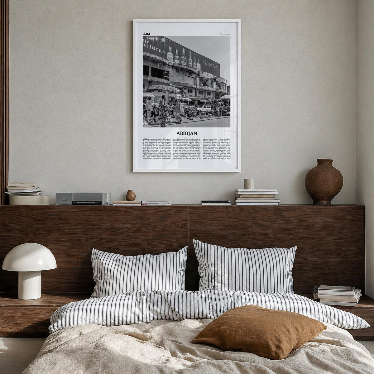 Abidjan black & white newspaper poster of Côte d'Ivoire – vertical wall art in white wood frame, hanging on wall