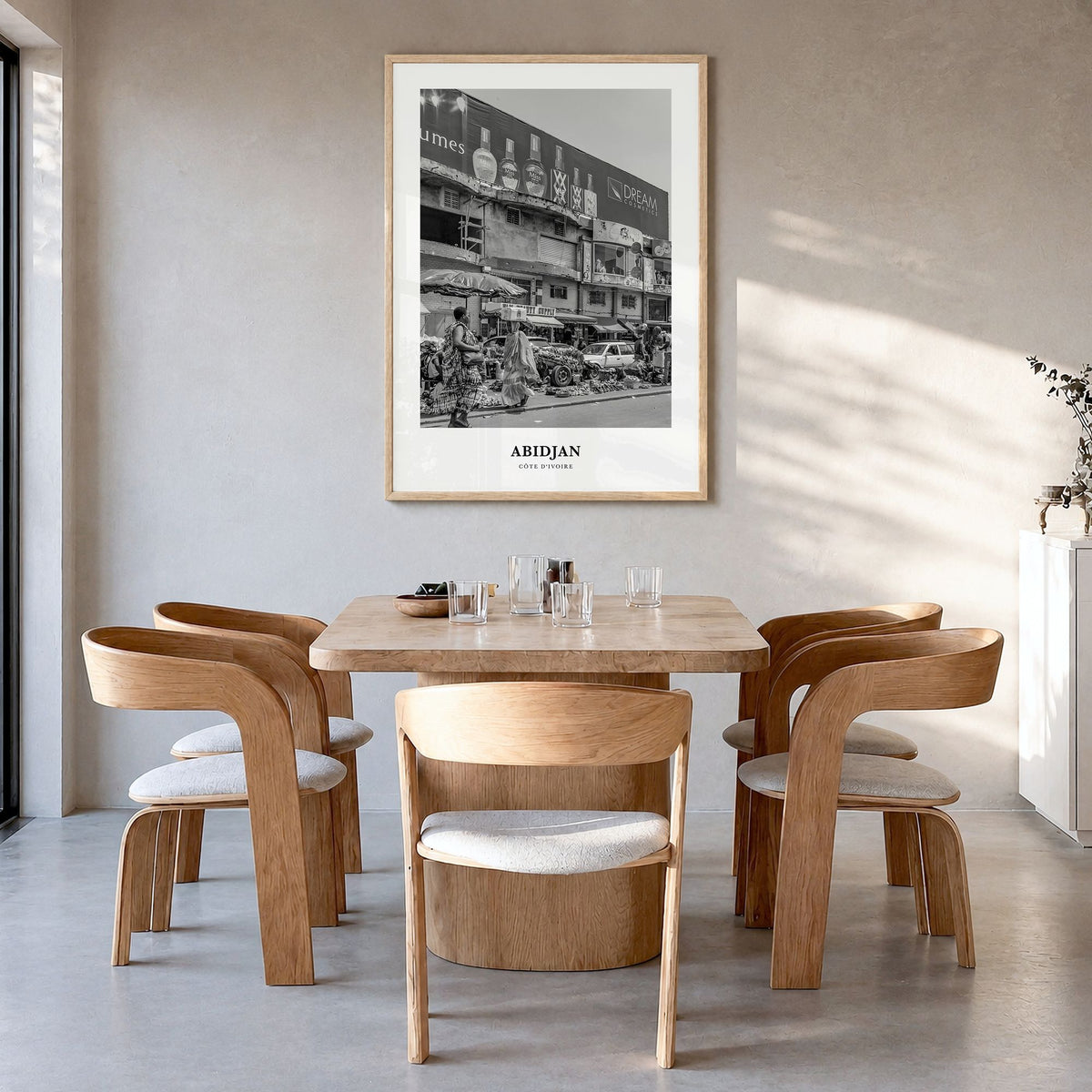 Abidjan Classic Poster in a natural wood frame, hanging in a dining room