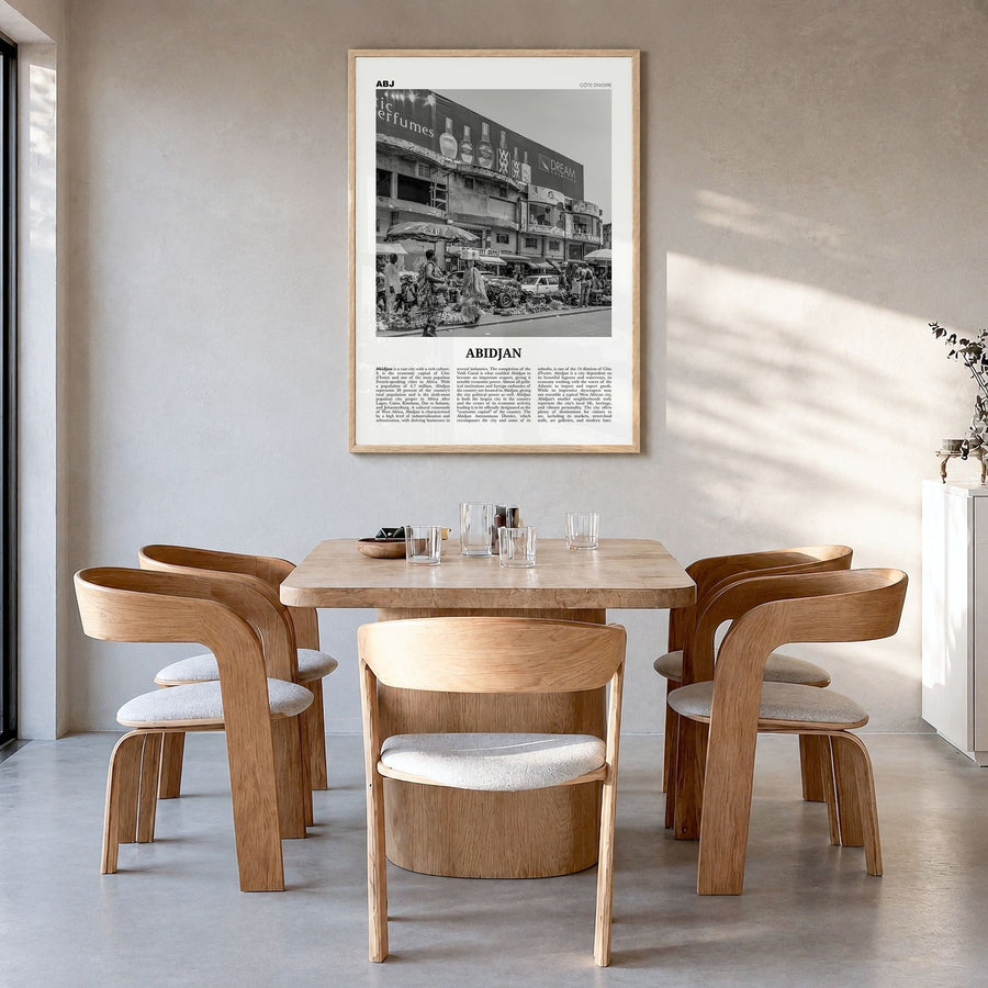 Abidjan Newspaper Poster in a natural wood frame, hanging in a dining room
