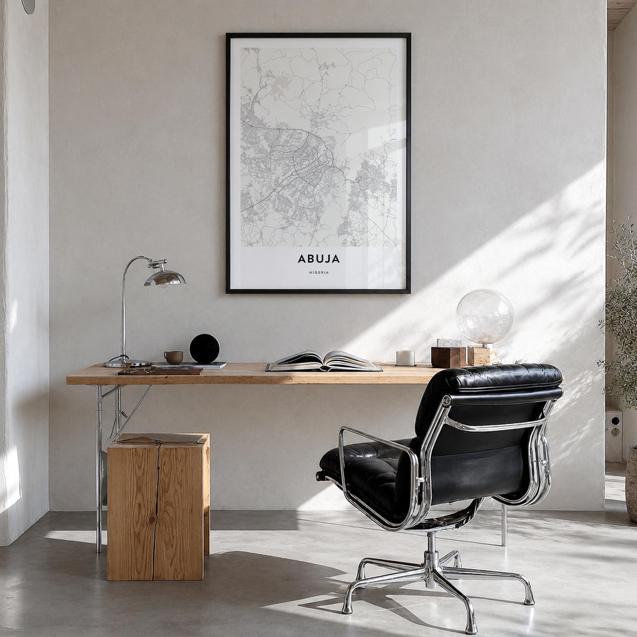 Abuja black & white map poster of Nigeria – vertical wall art in black wood frame, hanging on wall