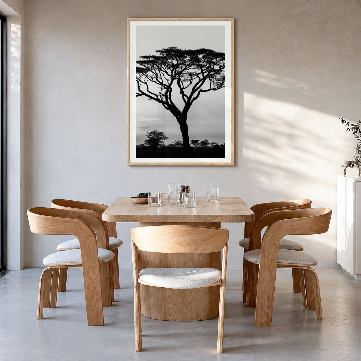Acacia Tree Photo Poster in a natural wood frame, hanging in a dining room, white border