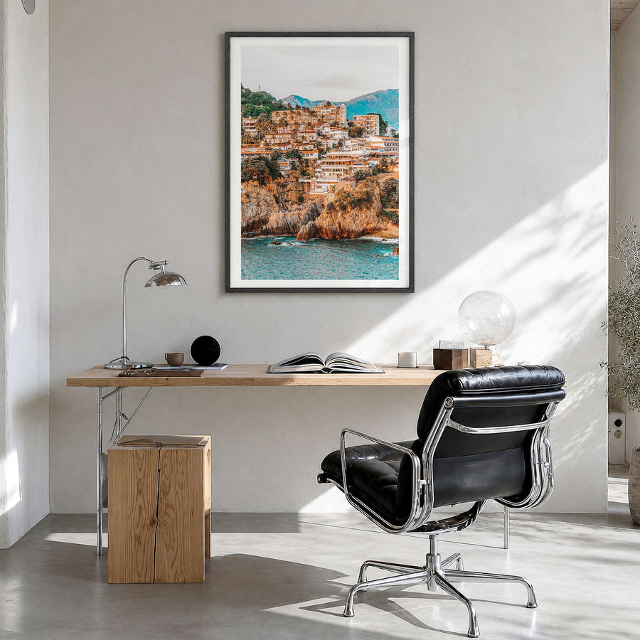Acapulco Photo Poster in a black wood frame, hanging in a bright home office, white border