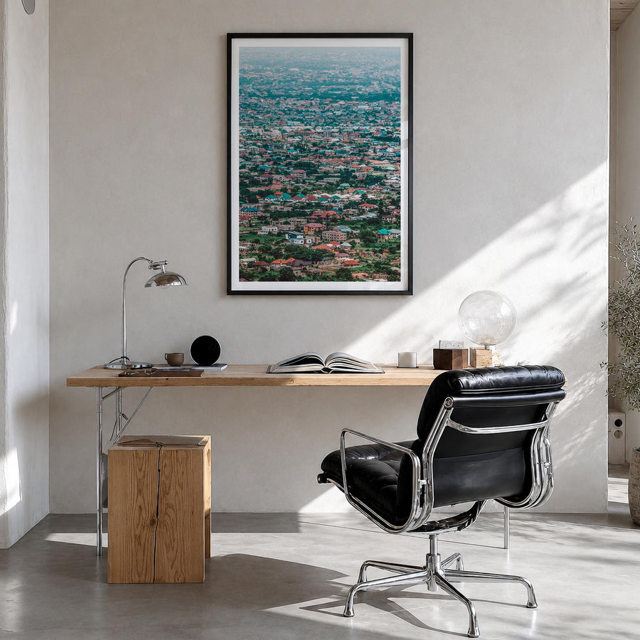 Accra colorful photo poster of Ghana – vertical wall art in black wood frame with white border, hanging on wall