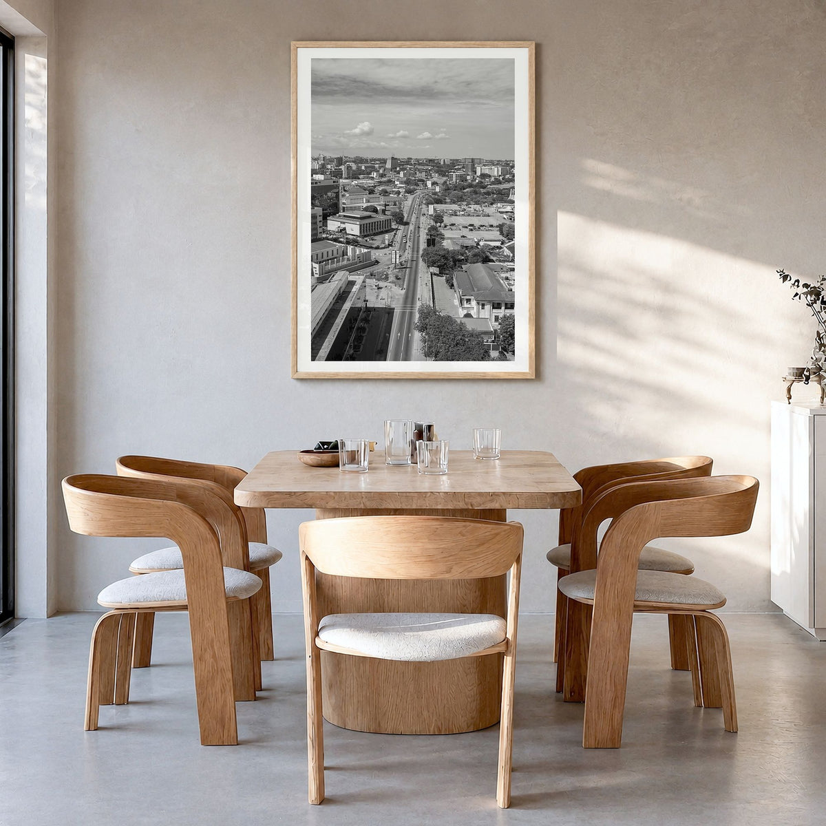 Accra Photo Poster in a natural wood frame, hanging in a dining room, white border