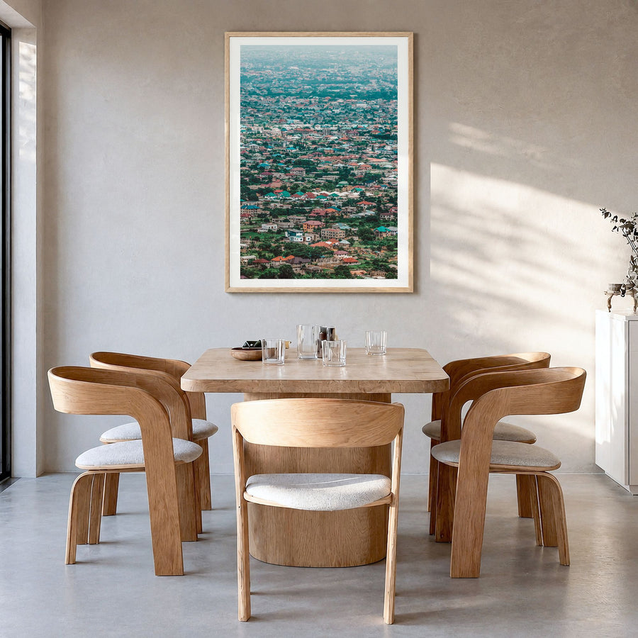 Accra Photo Poster in a natural wood frame, hanging in a dining room, white border