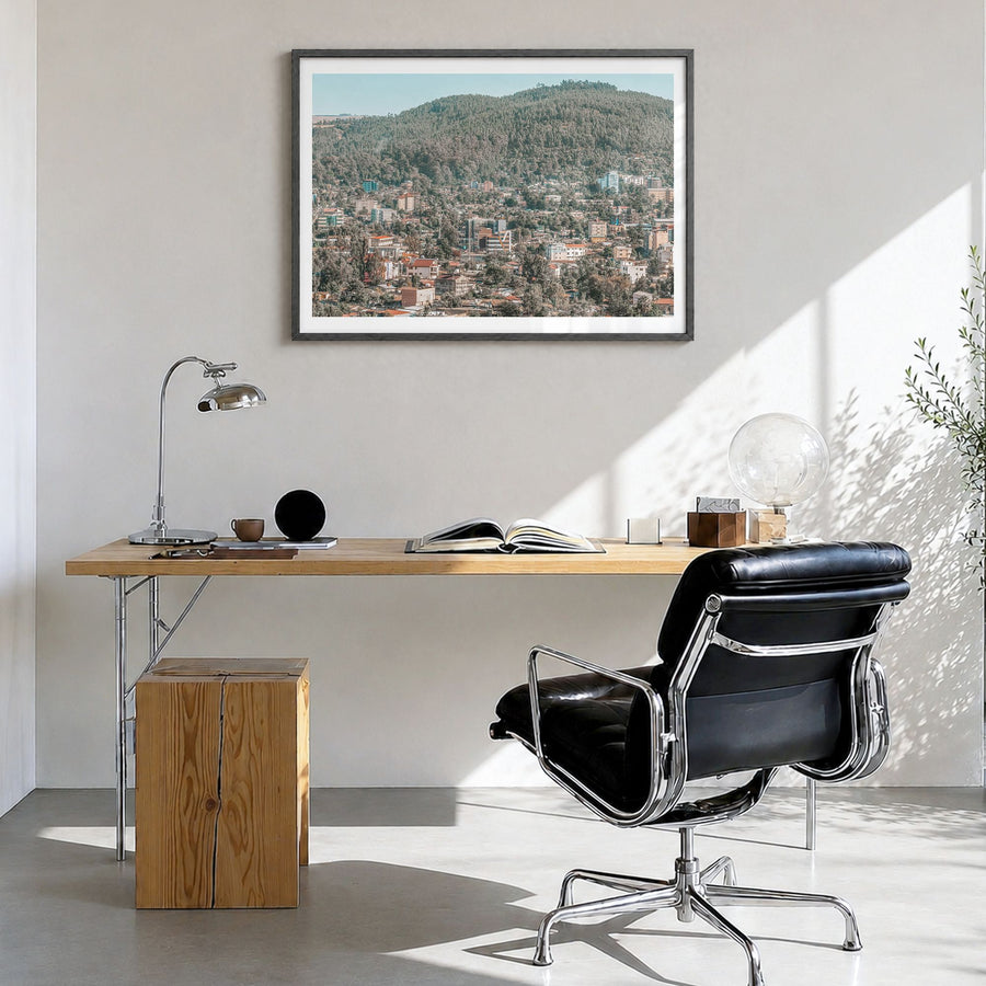 Addis Ababa Photo Poster in a black wood frame, hanging in a bright home office, white border