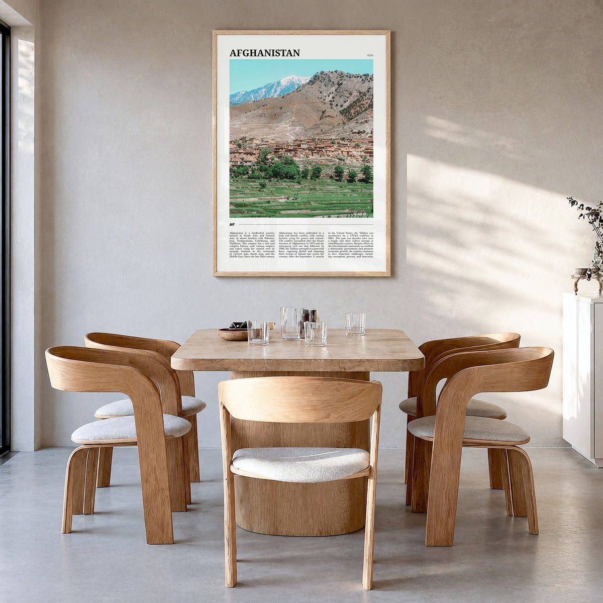 Afghanistan Travel Poster in a natural wood frame, hanging in a dining room