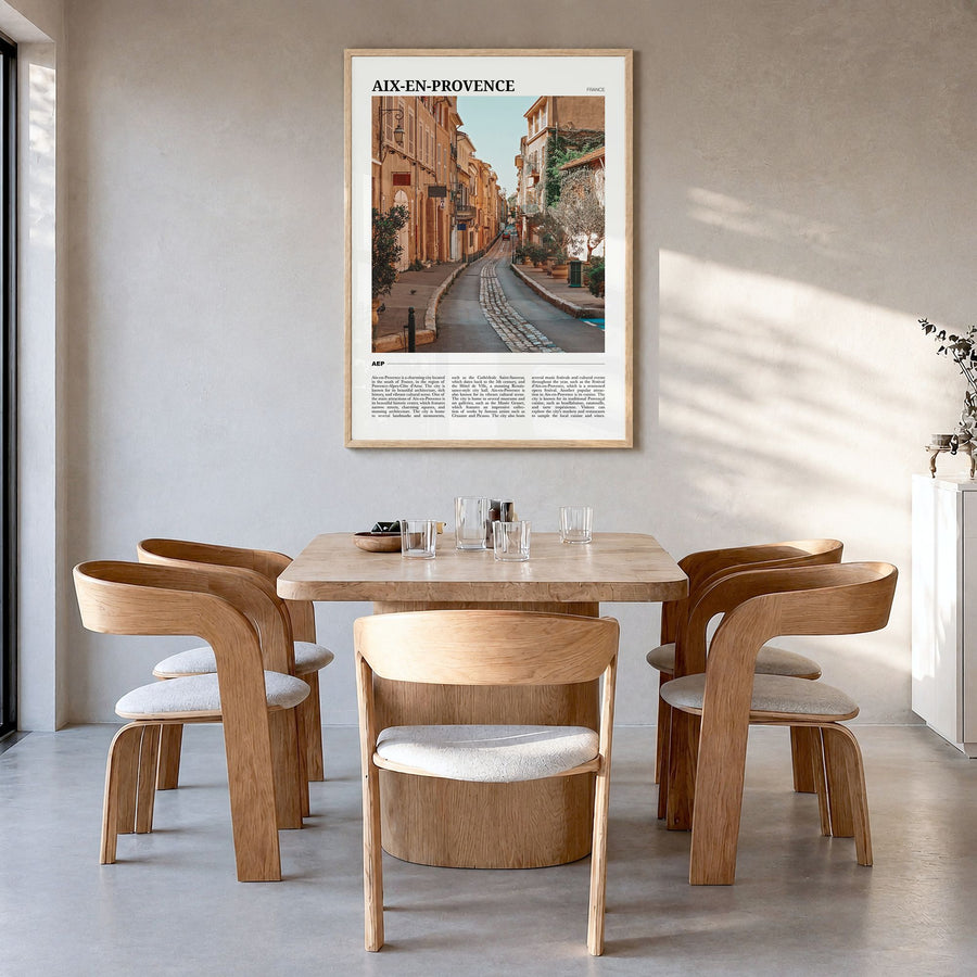 Aix-en-Provence Travel Poster in a natural wood frame, hanging in a dining room
