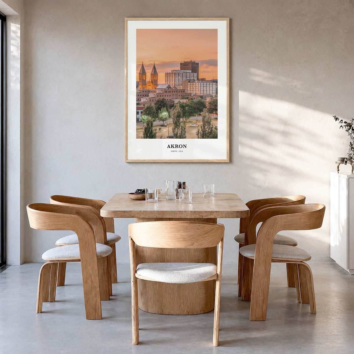 Akron Classic Poster in a natural wood frame, hanging in a dining room