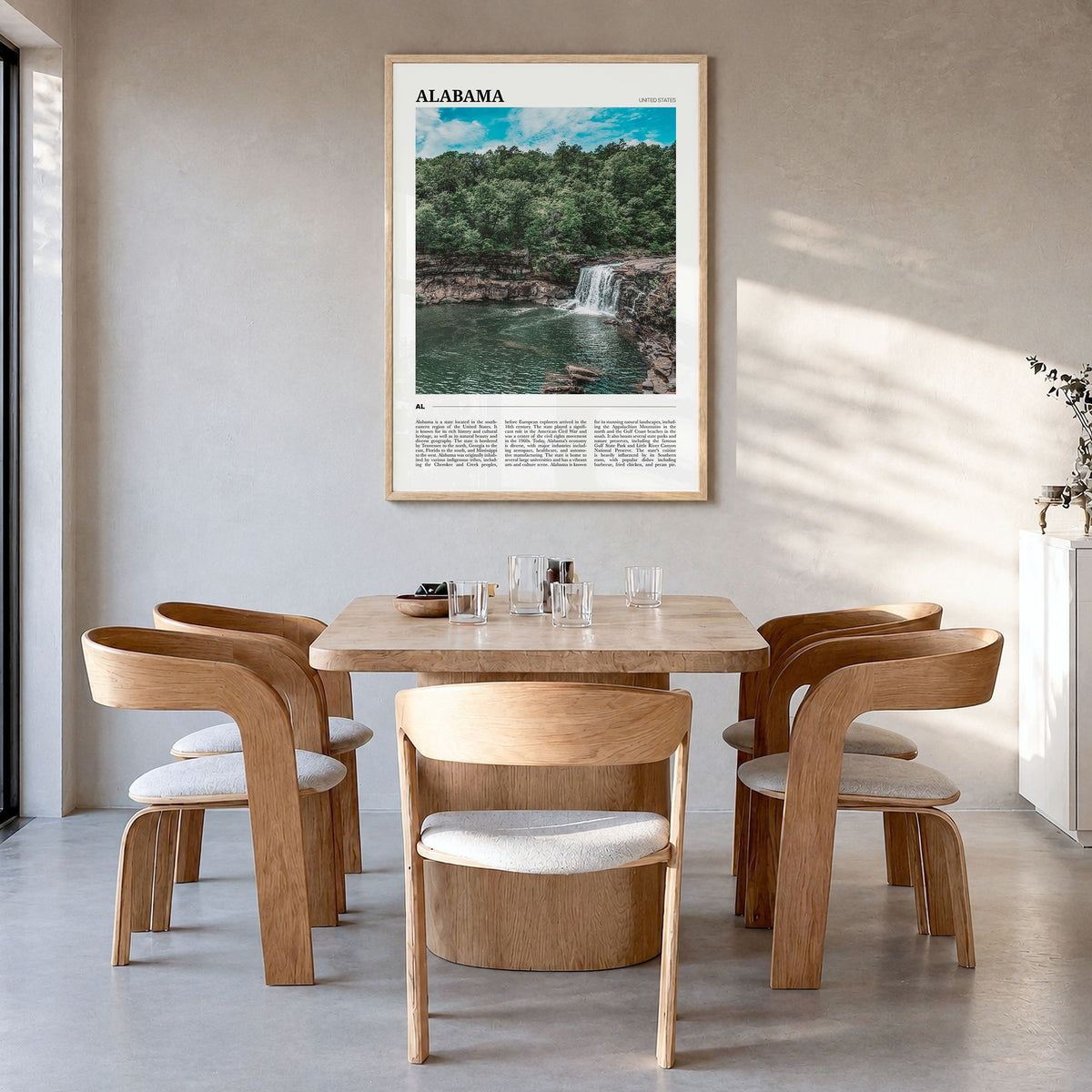 Alabama Travel Poster in a natural wood frame, hanging in a dining room