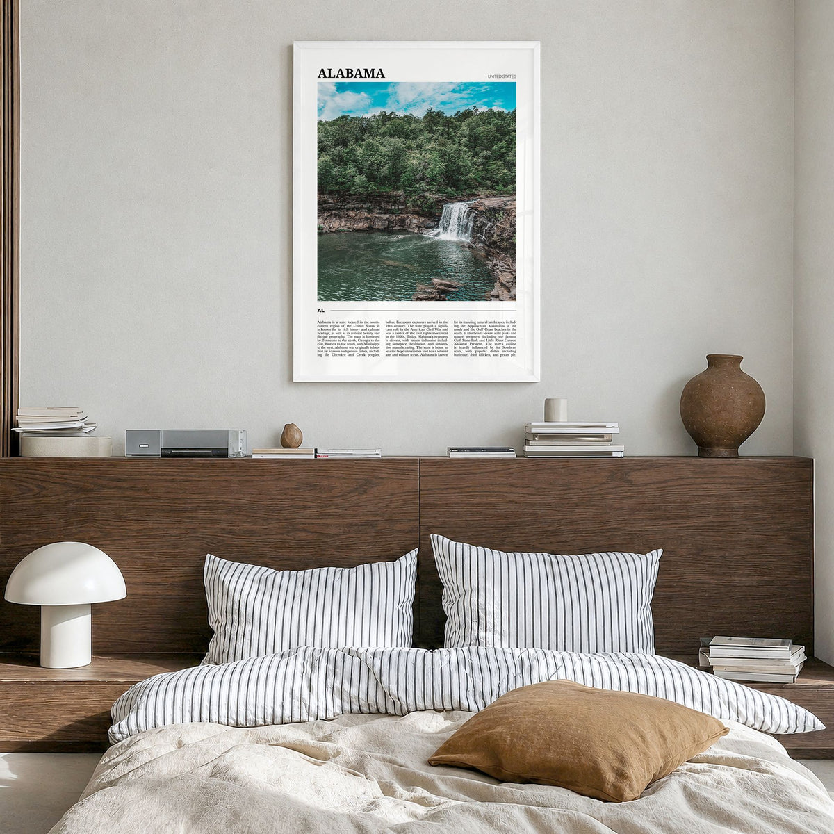 Alabama Travel Poster in a white wood frame, hanging in a bedroom