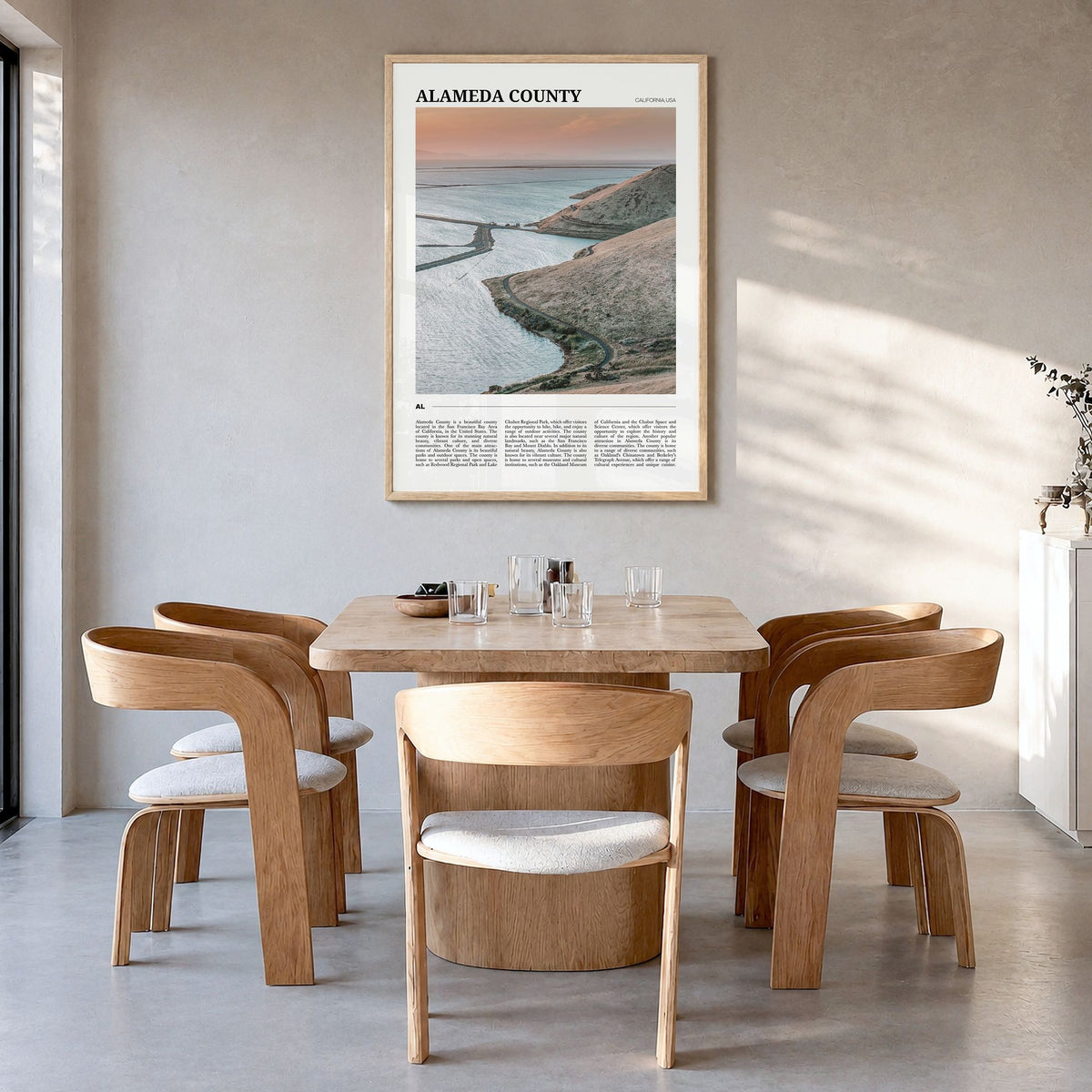 Alameda County Travel Poster in a natural wood frame, hanging in a dining room