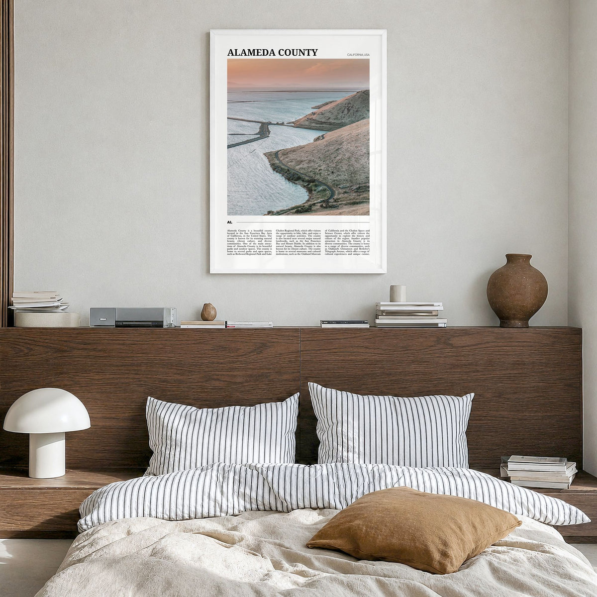 Alameda County Travel Poster in a white wood frame, hanging in a bedroom