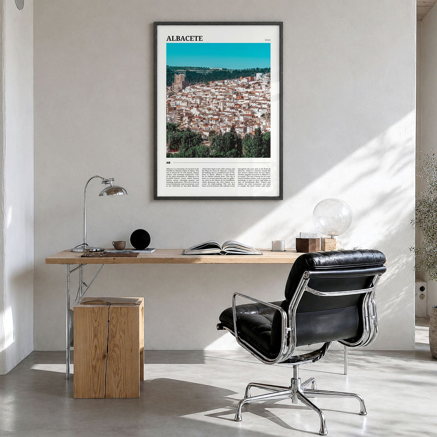 Albacete Travel Poster in a black wood frame, hanging in a bright home office