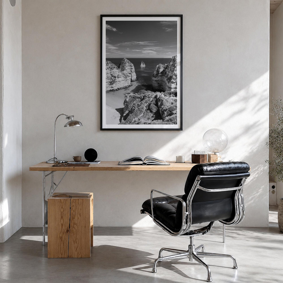 Algarve black & white photo poster of Portugal – vertical wall art in black wood frame with white border, hanging on wall