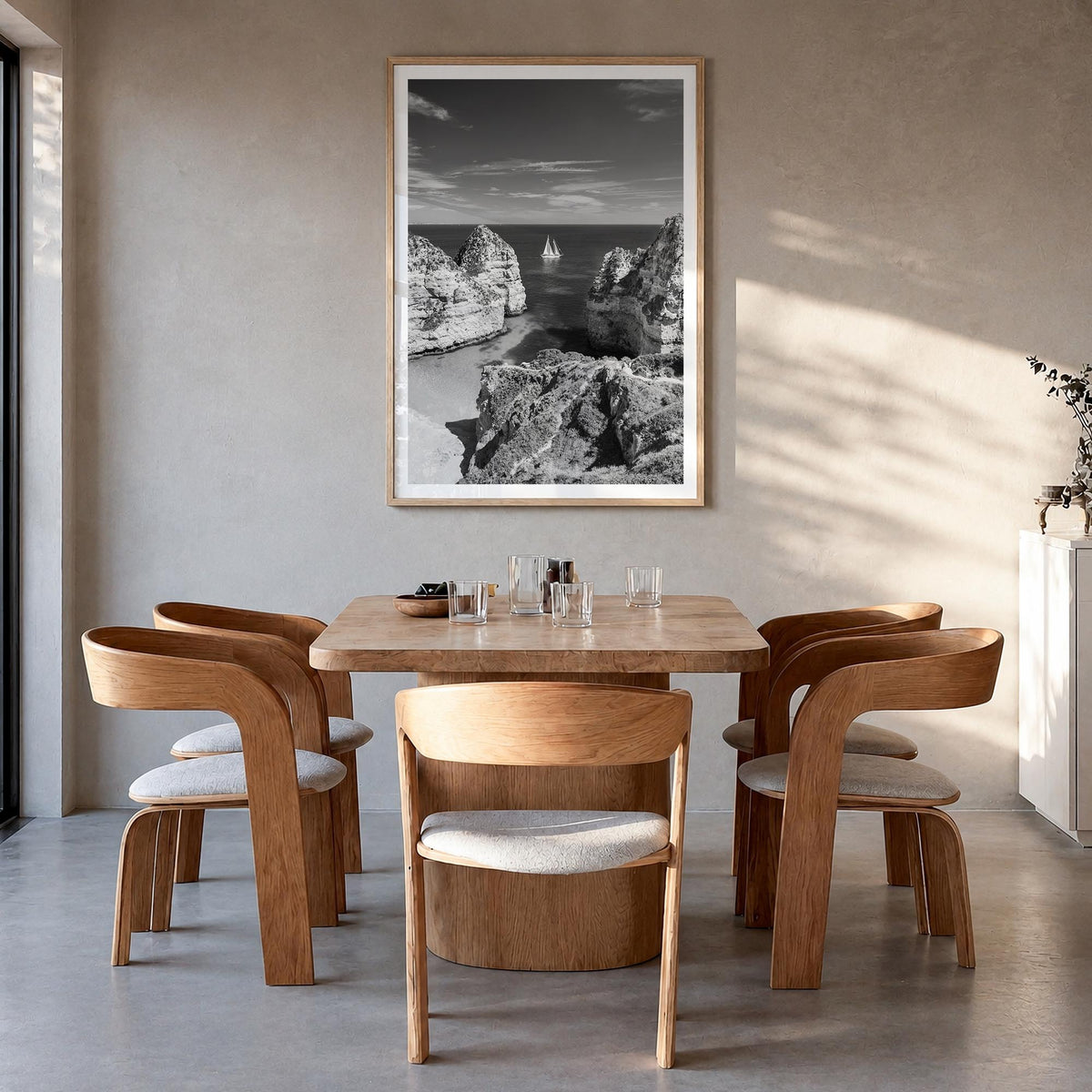Algarve black & white photo poster of Portugal – vertical wall art in natural wood frame with white border, hanging on wall