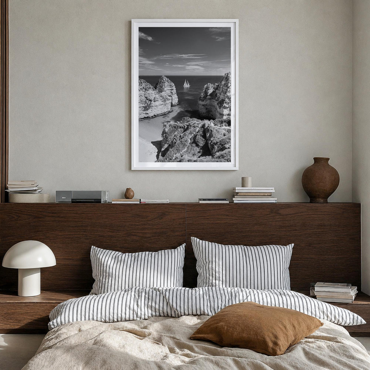 Algarve black & white photo poster of Portugal – vertical wall art in white wood frame with white border, hanging on wall