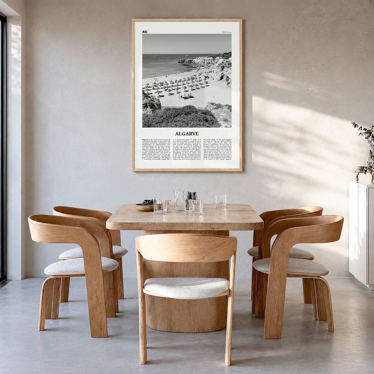 Algarve Newspaper Poster in a natural wood frame, hanging in a dining room
