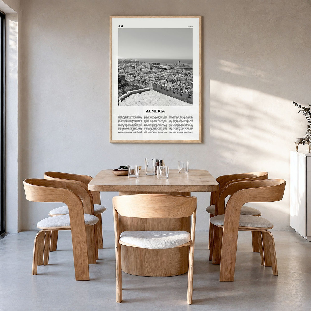 Almería Newspaper Poster in a natural wood frame, hanging in a dining room
