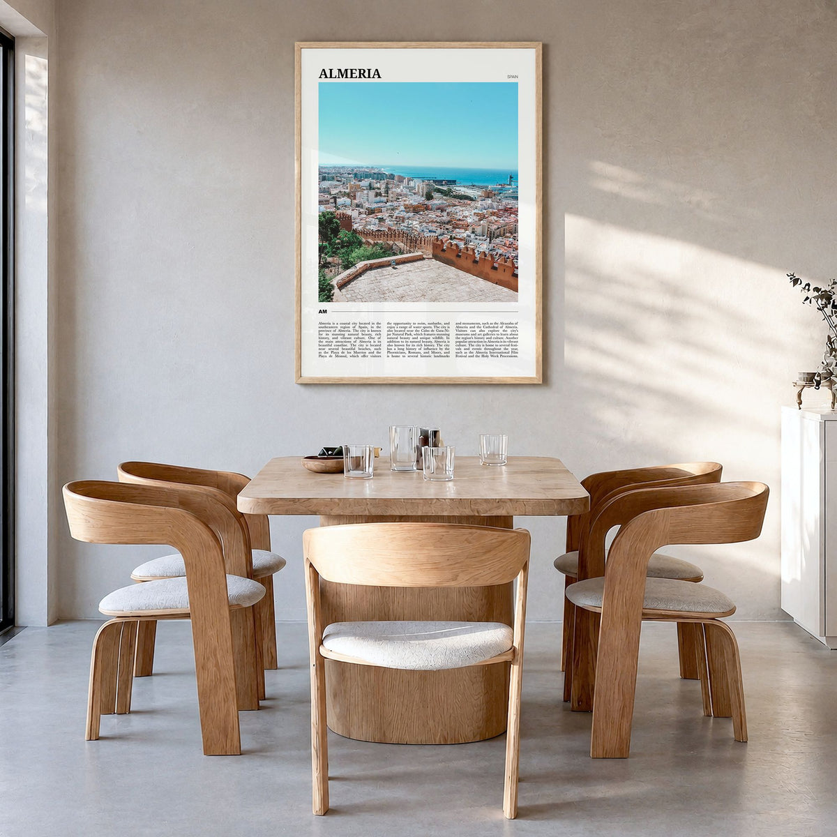Almería Travel Poster in a natural wood frame, hanging in a dining room