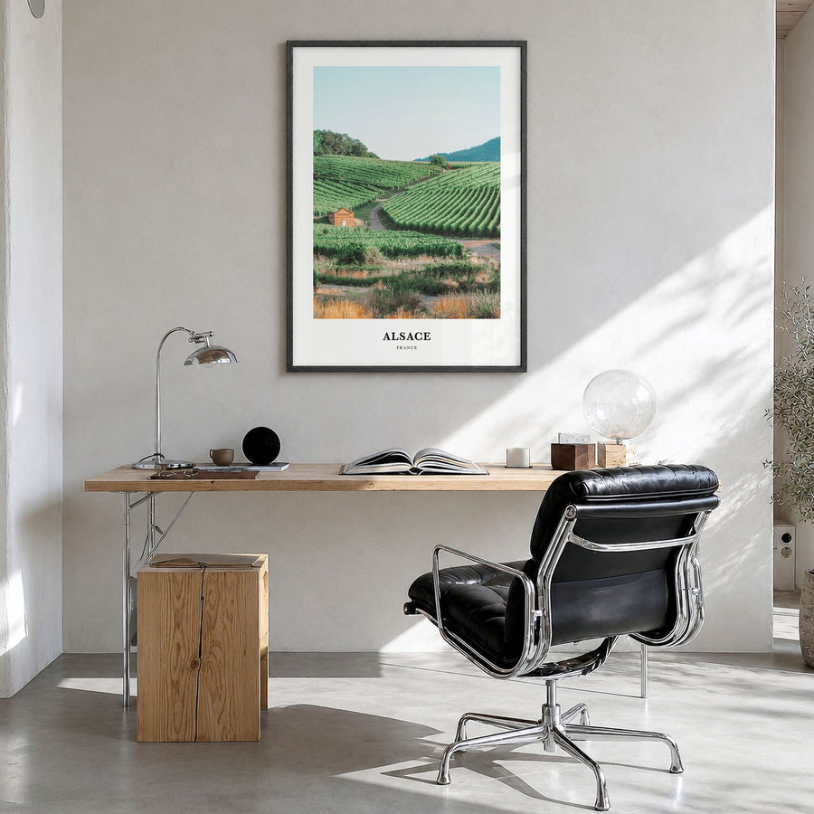 Alsace Classic Poster in a black wood frame, hanging in a bright home office