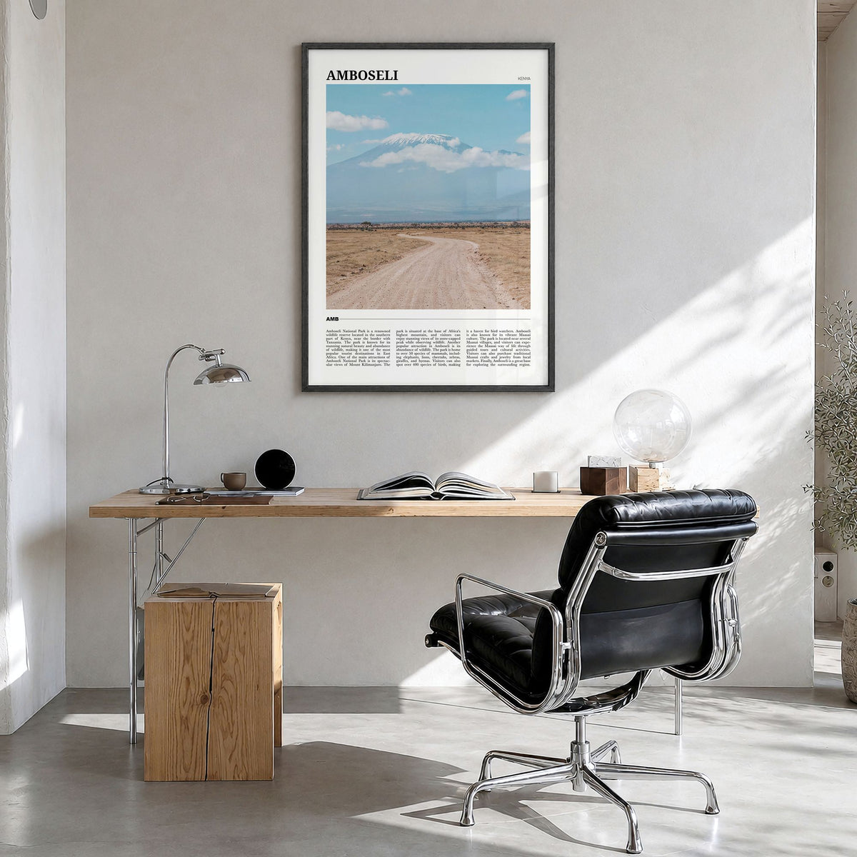 Amboseli Travel Poster in a black wood frame, hanging in a bright home office