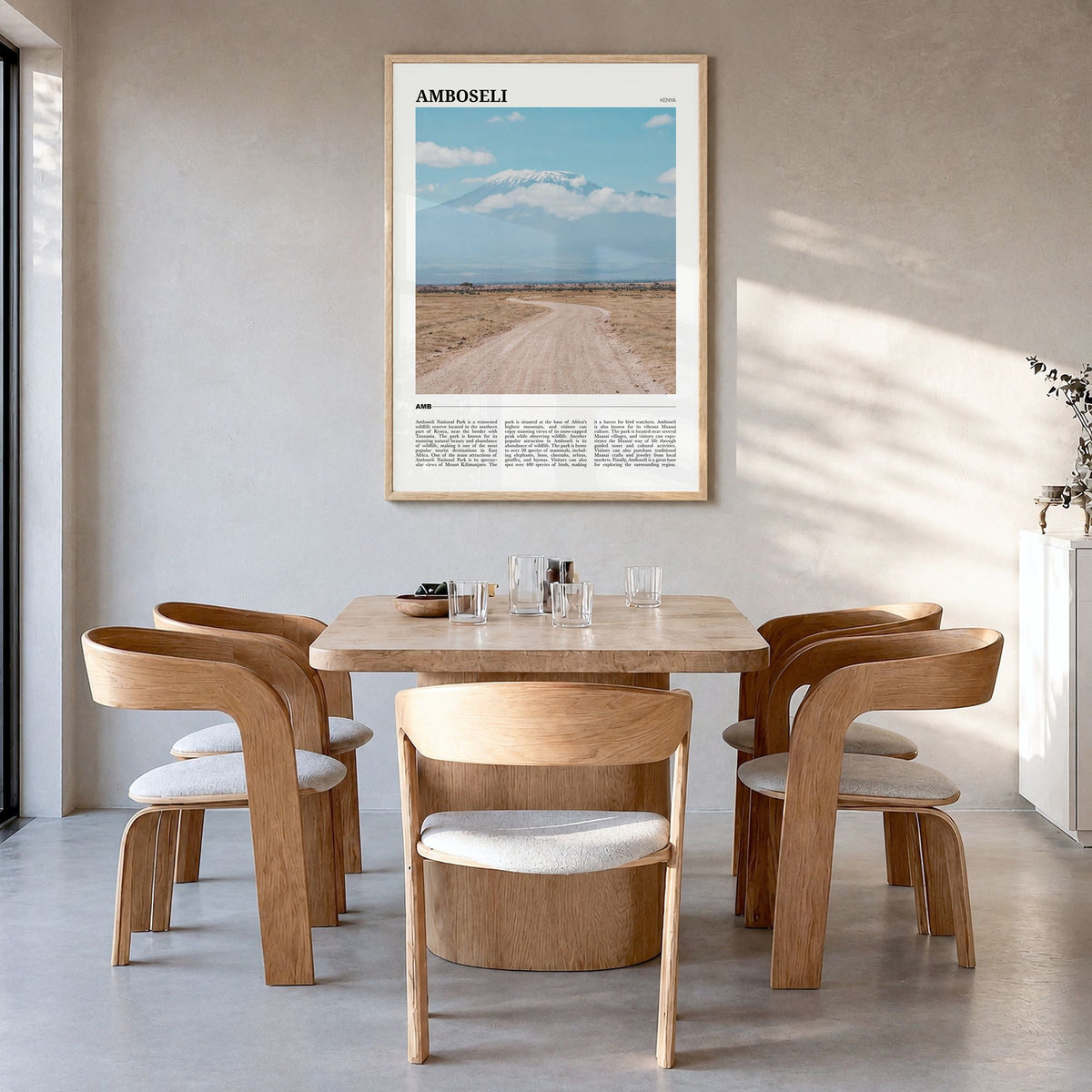 Amboseli Travel Poster in a natural wood frame, hanging in a dining room