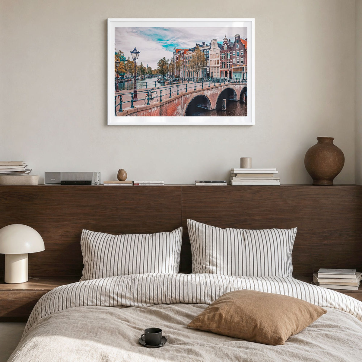 Amsterdam Photo Poster in a white wood frame, hanging in a bedroom, white border