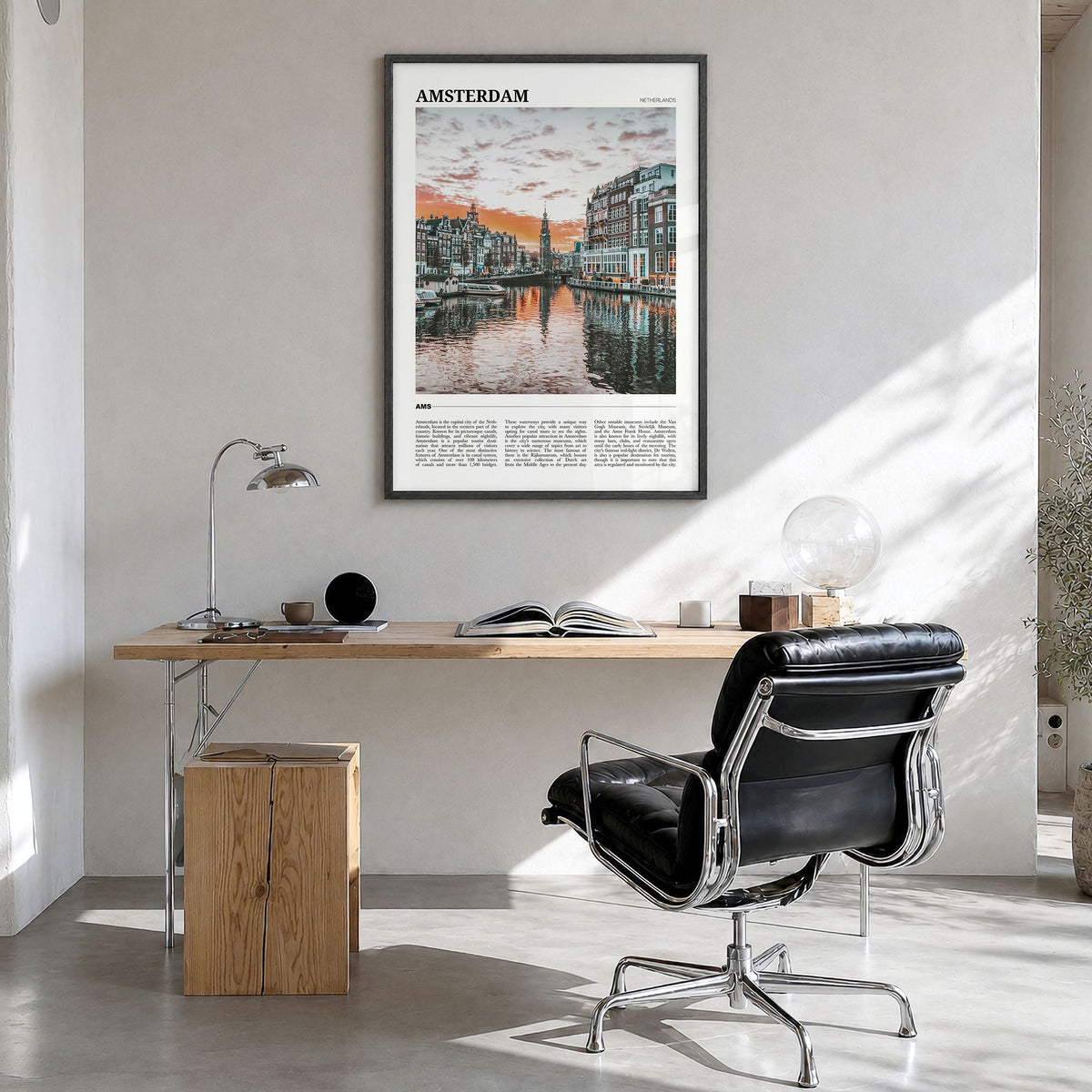 Amsterdam Travel Poster in a black wood frame, hanging in a bright home office
